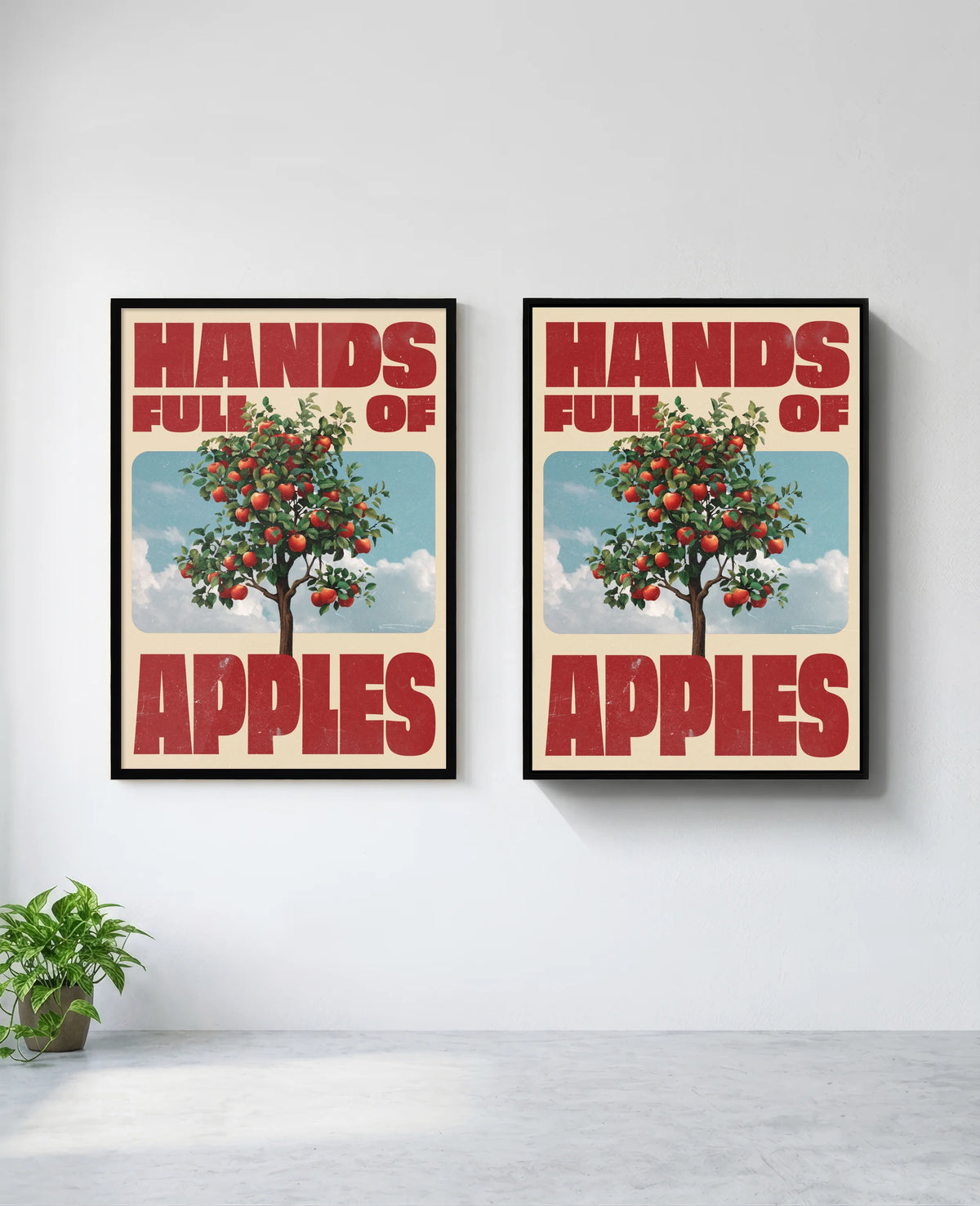 Hands Full of Apples art print in black frame, installed on wall