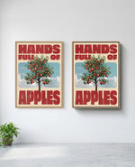 Hands Full of Apples art print in natural-wood frame, installed on wall