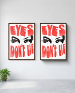Eyes Don't Lie art print in brown frame, installed on wall