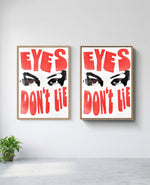 Eyes Don't Lie art print in natural-wood frame, installed on wall