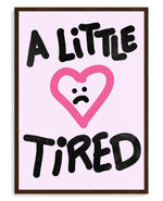 A Little Tired art print, framed in brown wood with acrylic glazing