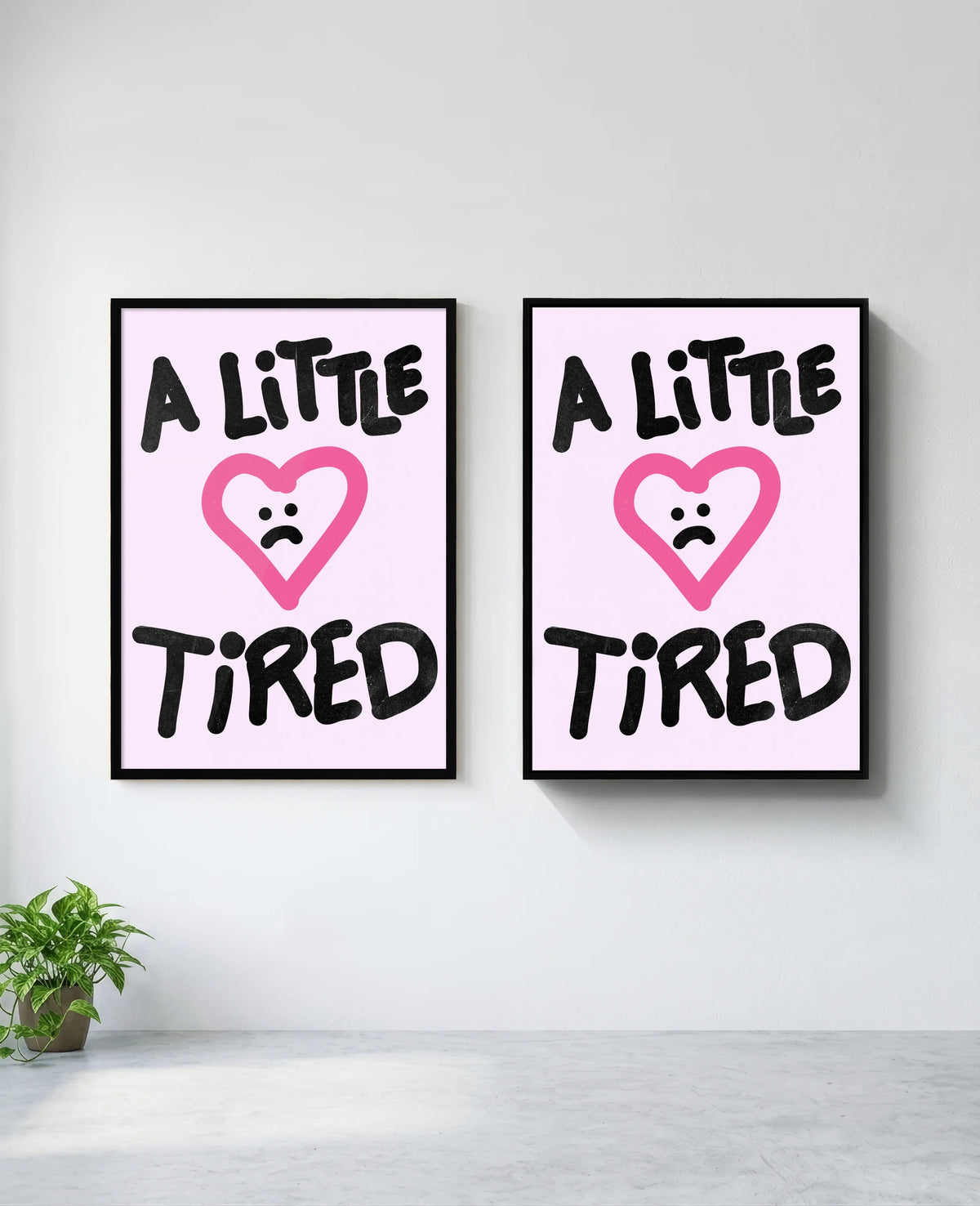 A Little Tired art print in black frame, installed on wall