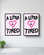 A Little Tired art print in black frame, installed on wall