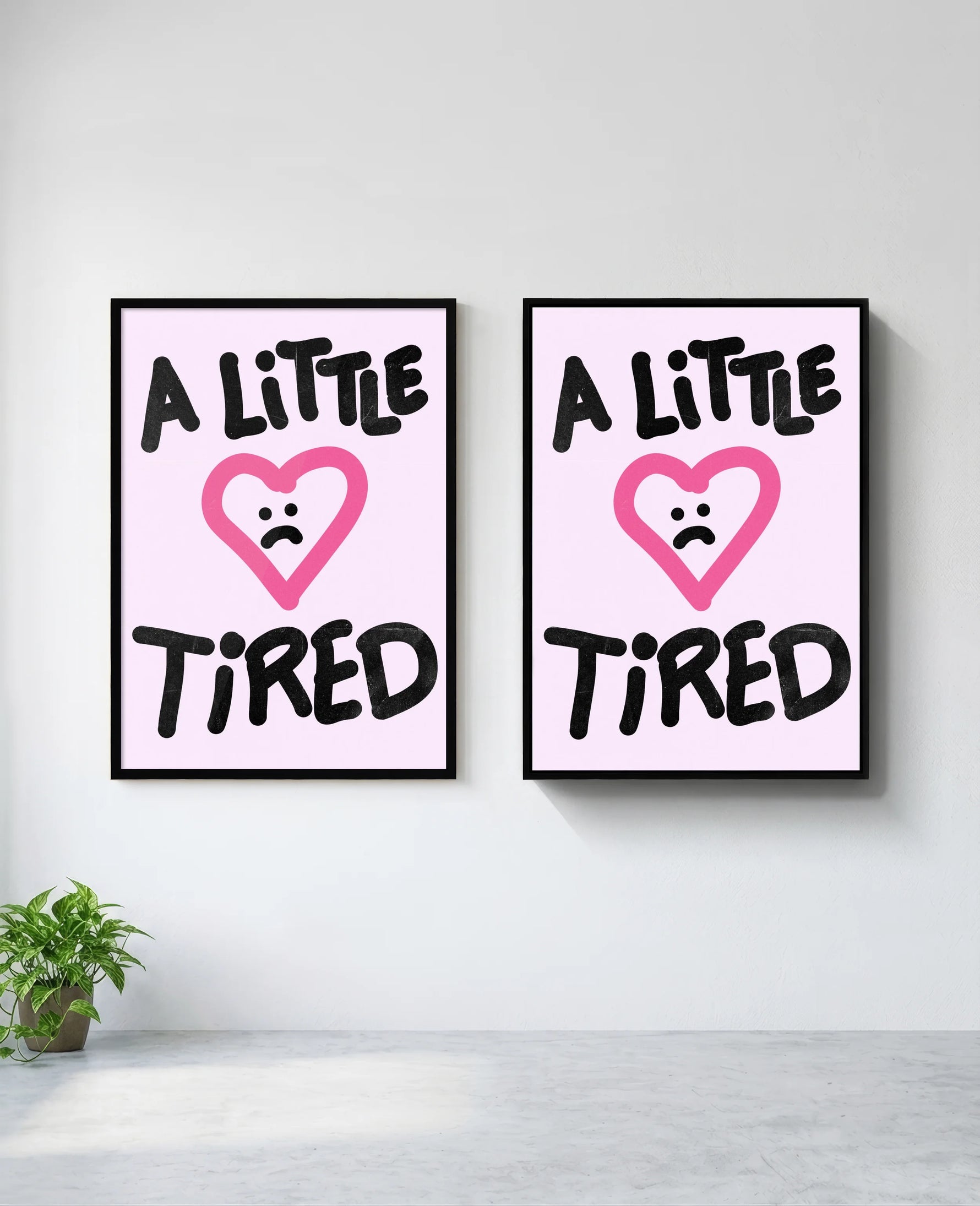 A Little Tired art print in black frame, installed on wall