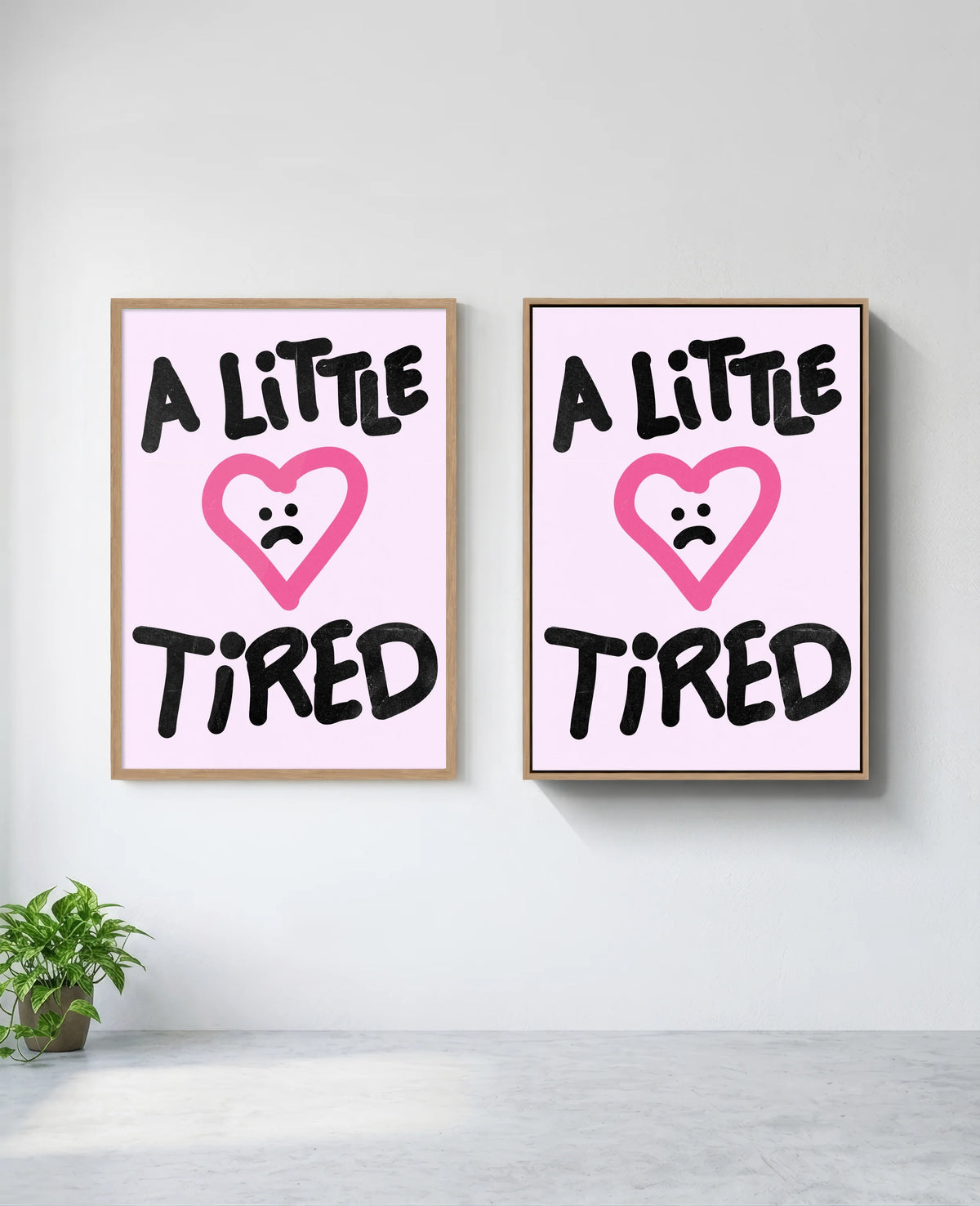 A Little Tired art print in natural-wood frame, installed on wall