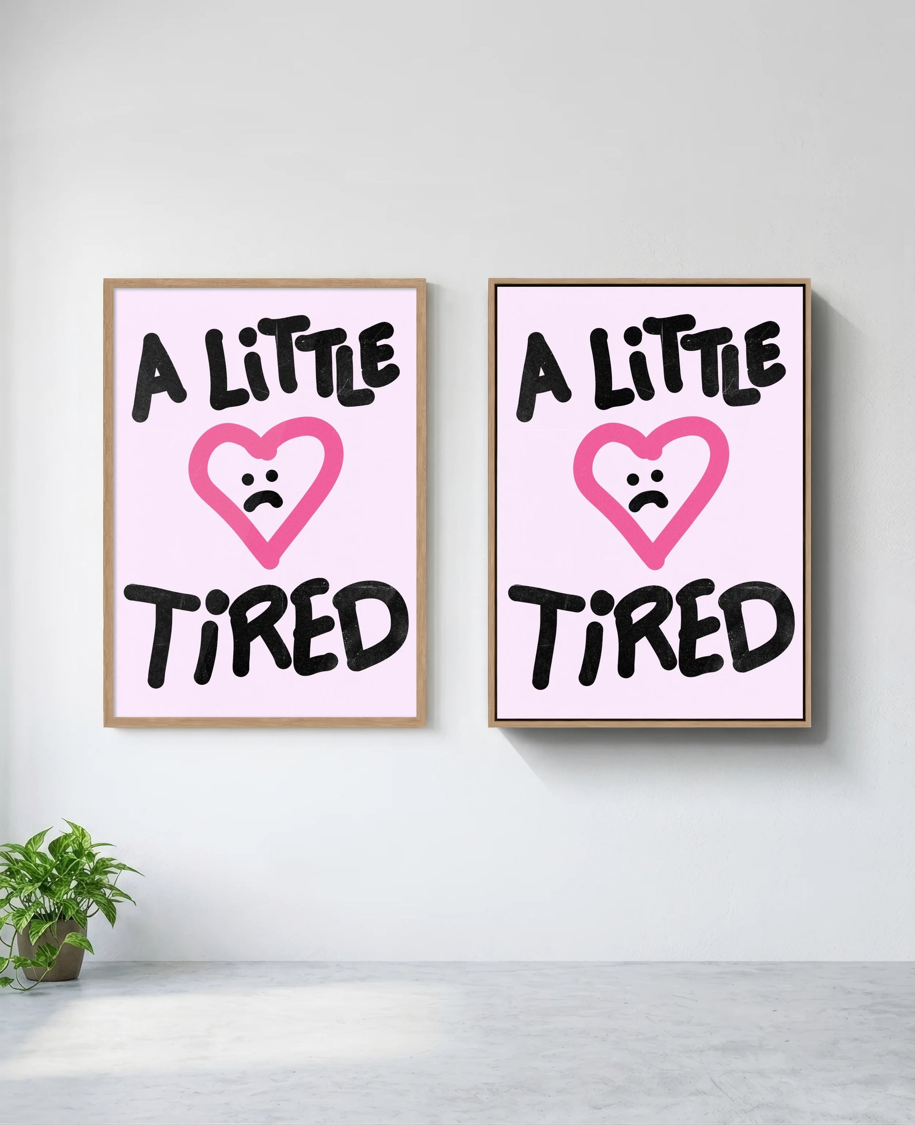 A Little Tired art print in natural-wood frame, installed on wall