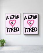 A Little Tired art print in white frame, installed on wall