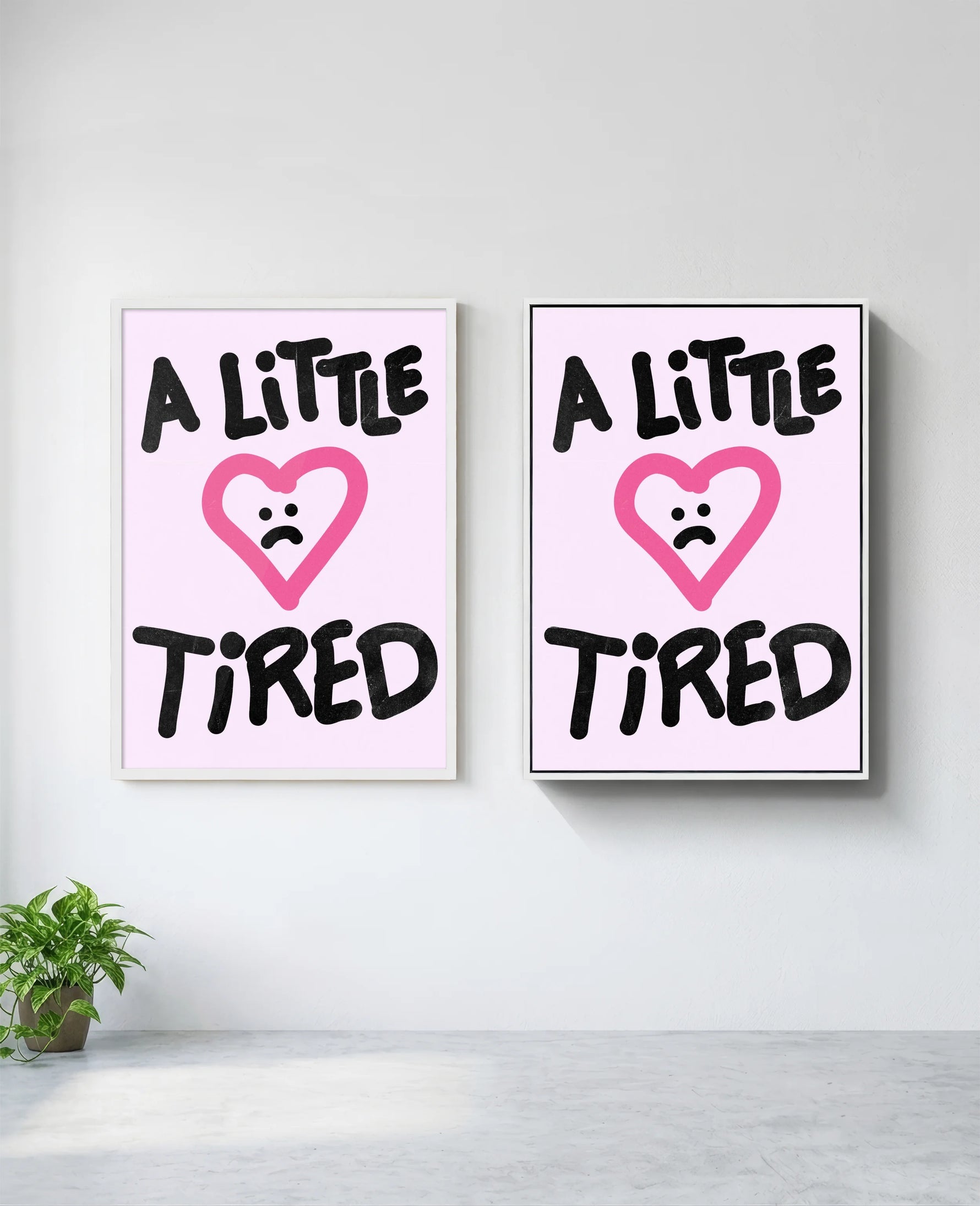 A Little Tired art print in white frame, installed on wall
