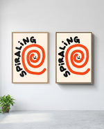 Spiraling art print in natural-wood frame, installed on wall